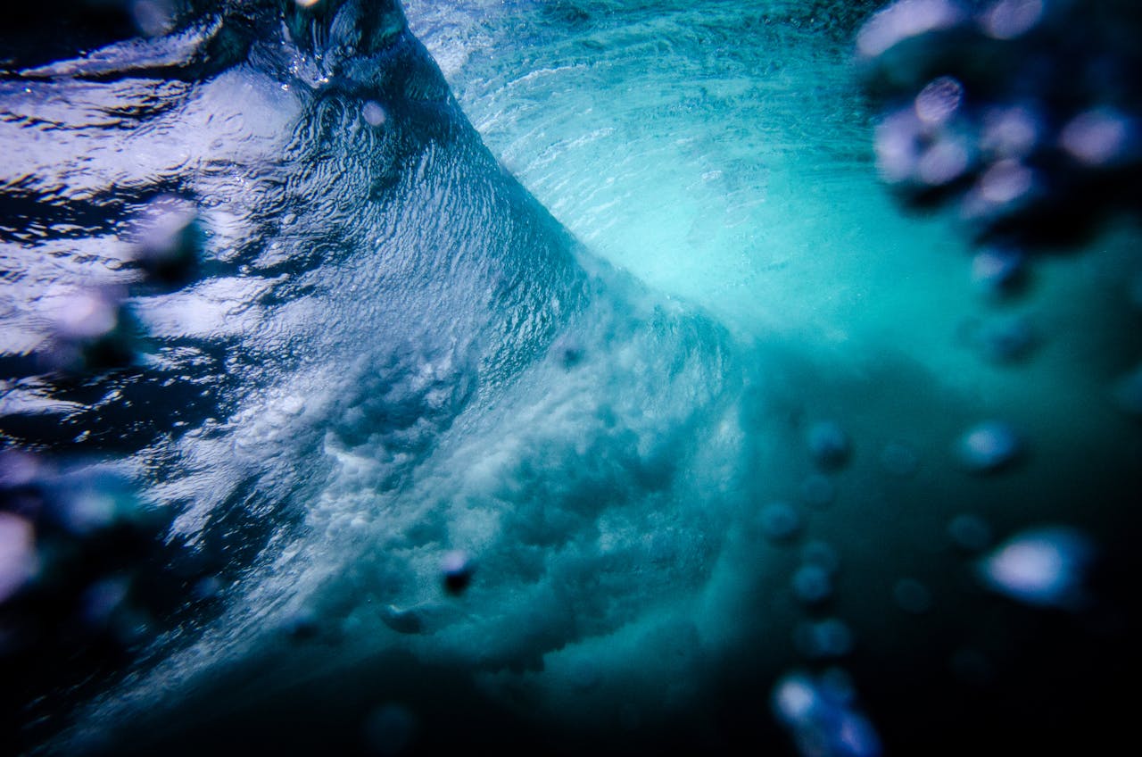 Capture the mesmerizing motion and dynamic beauty of an underwater wave scene.